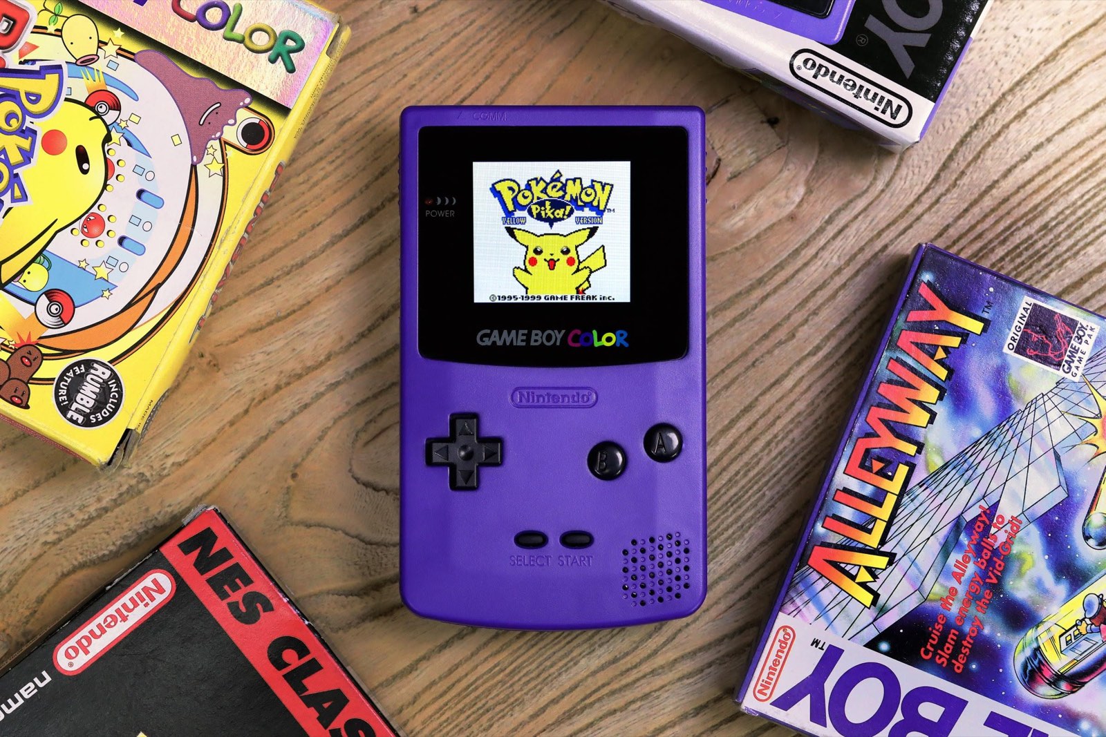 A modded retro handheld console with a glowing backlit screen